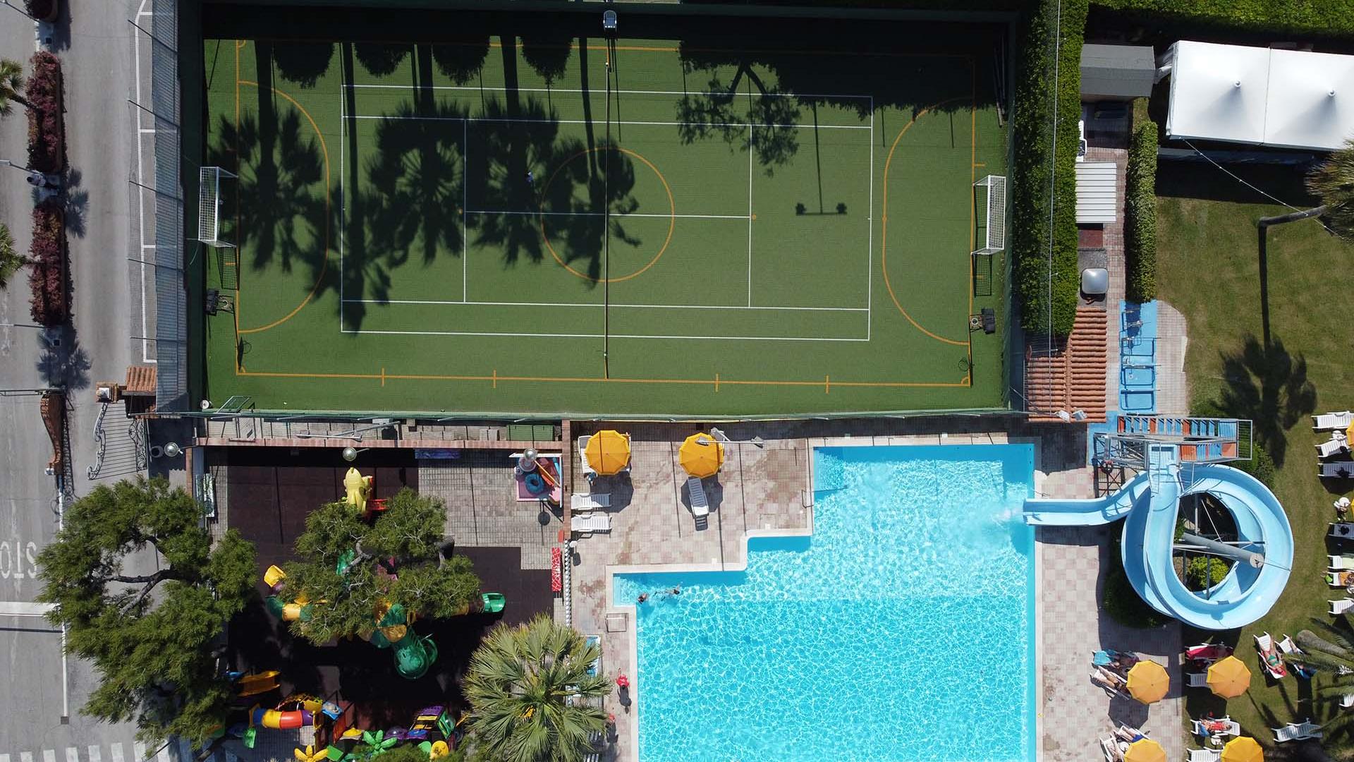 Aerial view of pool, slide, and sports field.